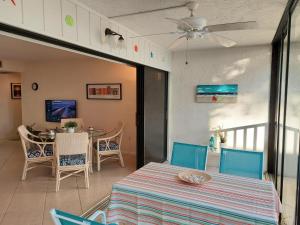 a dining room with a table and chairs at Midnight Cove II 128F in Siesta Key