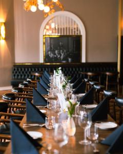 a long table in a room with tables and chairs at Hotel Borg by Keahotels in Reykjavík
