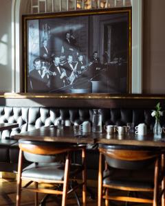 a dining room with a table and a picture on the wall at Hotel Borg by Keahotels in Reykjavík