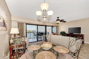 a living room with two tables and a couch at Midnight Cove II 134F in Siesta Key