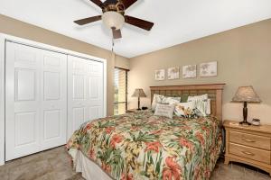 a bedroom with a bed and a ceiling fan at Midnight Cove II 134F in Siesta Key +72 photos