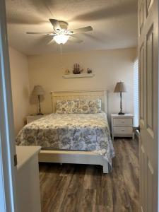 a bedroom with a bed and a ceiling fan at Midnight Cove II 211F in Siesta Key +28 photos