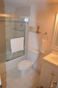 a bathroom with a toilet and a shower at Midnight Cove II 211F in Siesta Key