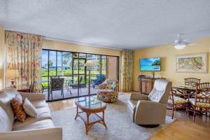 a living room with a couch and chairs and a table at Midnight Cove II 213F in Siesta Key