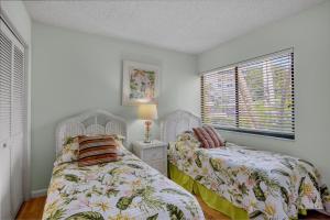 two beds in a room with two windows at Midnight Cove II 213F in Siesta Key +68 photos