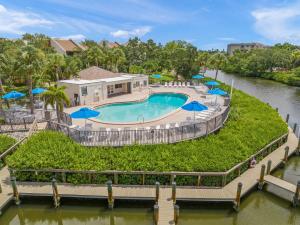 an overhead view of a swimming pool with umbrellas at Midnight Cove II 212F in Siesta Key