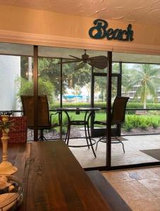 a dining room with a table and chairs in a room at Midnight Cove II 212F in Siesta Key