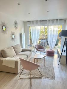 a living room with a couch and a table at La Maison de Juliette in Agon Coutainville