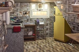 a kitchen with a yellow refrigerator and a sink at Sunset Guest house in Cairo
