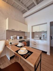 a kitchen with a wooden table in a room at Edificio Lawa Calyptus in Montevideo
