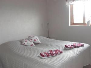Una cama blanca con cuatro almohadas encima. en Awesome Home In Löderup With Two Bedrooms And Wifi, en Sandby