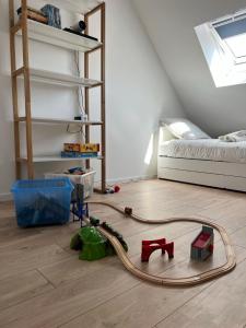 a room with a hose on the floor next to a bed at Maison idéale famille, 6 pers - Disney 15 min in Quincy-Voisins +3 photos