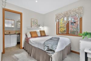 a bedroom with a large bed and a window at VT Lake house minutes from Okemo in Ludlow