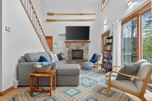 a living room with two chairs and a fireplace at VT Lake house minutes from Okemo in Ludlow