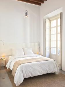 1 dormitorio blanco con 1 cama grande y paredes blancas en Suncity Ismo Arquitectura, en Málaga