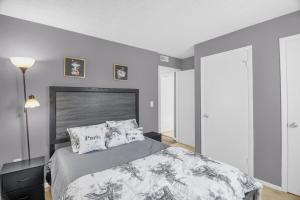 a bedroom with a large bed with a gray wall at Modern 3BR 2 bathroom Near High Point University & Market Sleeps 6 in High Point