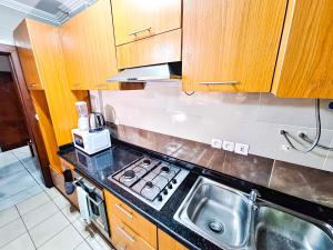 a kitchen with a sink and a stove top oven at Belmann Bonapriso in Douala