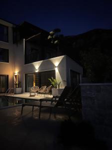 a patio with chairs and a table in front of a building at Vila panorama in Budva