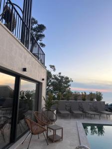 a patio with chairs and a pool on a building at Vila panorama in Cetinje