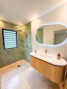 a bathroom with a sink and a shower with a mirror at SEA NOVA Friar's Bay Beachfront Properties in Saint Martin +29 photos