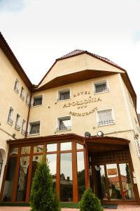 a building with a sign on the front of it at Hotel Apollonia in Braşov