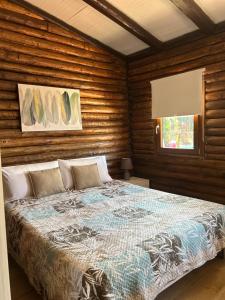 a bedroom with a bed in a room with wooden walls at Chalet Seaview by AR Group Hotels in Isola delle Femmine +66 photos