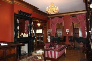 a living room with red walls and a fireplace at Villagio Boutique Hotel in Pittsburgh