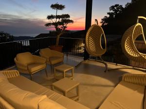 a patio with chairs and a couch on a balcony at Vila panorama in Cetinje