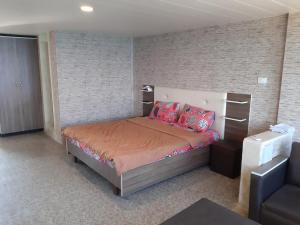 Ένα ή περισσότερα κρεβάτια σε δωμάτιο στο Mounes Hotel