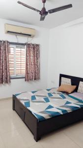 a bed in a bedroom with a ceiling at Elite Home Stay in Raipur