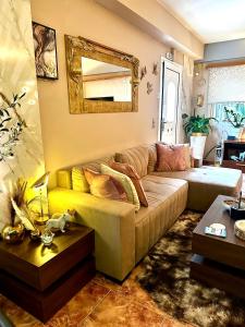 a living room with a couch and a mirror at luxury house airport in Koropíon