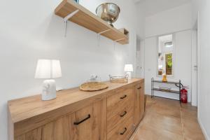a kitchen with a wooden counter with a lamp on it at Appartamento Matteo in Pula +38 photos