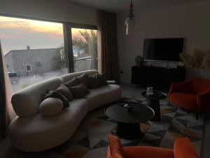 a living room with a couch and a large window at Vila panorama in Cetinje +44 photos