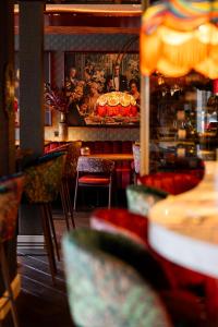a restaurant with tables and chairs in a room at Boutique Hotel de Statie in Valkenswaard