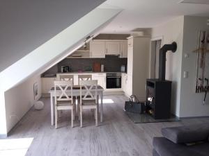 a kitchen and dining room with a table and a stove at Möwe in Lancken-Granitz