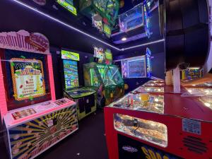 a room with arcade games and video game machines at Forest hart in Sway