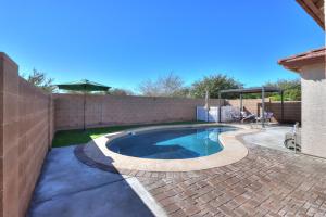 a swimming pool in a backyard with a fence at Private Mini Serene Oasis with Pool in Maricopa