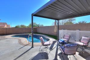 a patio with a canopy and chairs and a swimming pool at Private Mini Serene Oasis with Pool in Maricopa