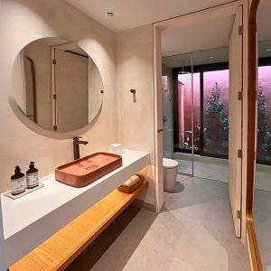 a bathroom with a sink and a mirror at Pousada Okas de Camburizinho in São Sebastião +35 photos