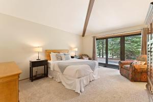 a bedroom with a bed and a large window at 10 Tan Oak in Sunriver