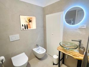 a bathroom with a toilet and a sink and a mirror at Da I Ciarui Casa Vacanze in Dolceacqua +26 photos