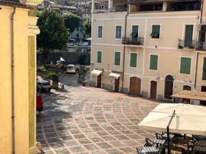 an empty cobblestone street in a city with buildings at Da I Ciarui Casa Vacanze in Dolceacqua