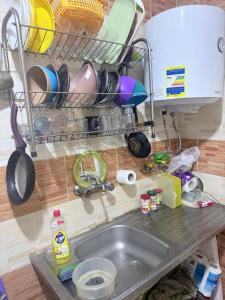 a kitchen counter with a sink and utensils at استوديو بجوار طلعت حرب in Cairo