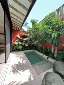 a small swimming pool on a balcony with plants at Pousada Okas de Camburizinho in São Sebastião