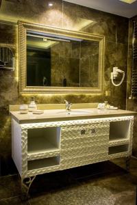 a bathroom with a sink and a mirror at Asya Hotel in Balıkesir +28 photos