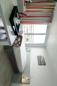 een trap in een huis met een groot raam bij City Résidence Ivry in Ivry-sur-Seine