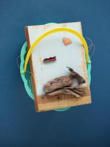 a bird sitting on top of a cutting board at De Museumkamer in Den Burg
