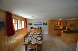 a kitchen with a long wooden table with dishes on it at Platane B 04 in Grimentz