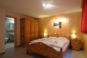 a bedroom with a large bed and a bathroom at Platane B 04 in Grimentz