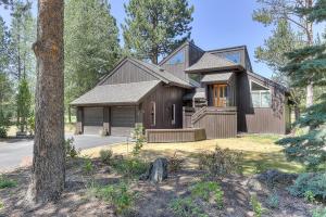 a brown house with a tree in front of it at 3 Spyglass in Sunriver